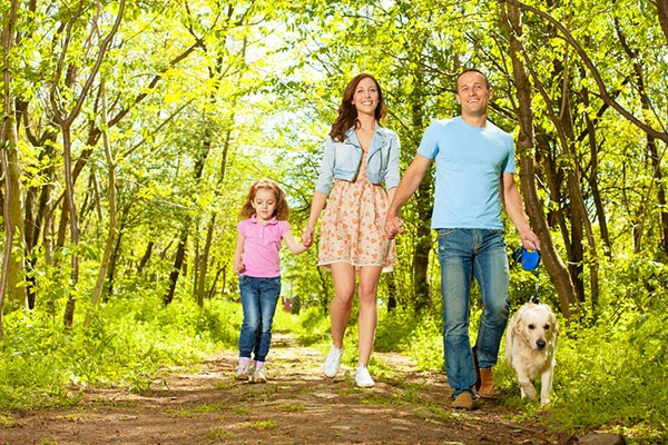 Family With Child and dog Walking Outdoors