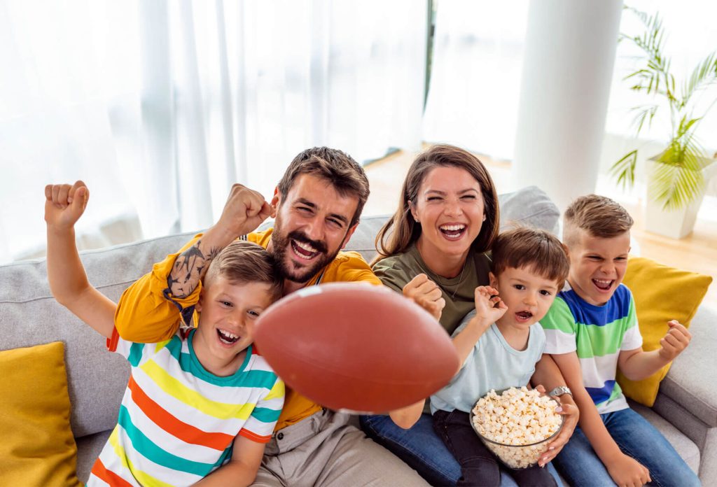 family at football party with snacks - New Home Community - New Construction Homes For Sale in Parrish, FL