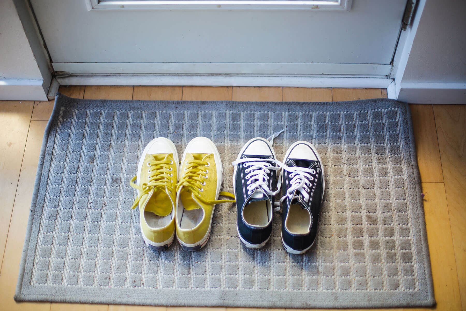Two pairs of shoes on doormat