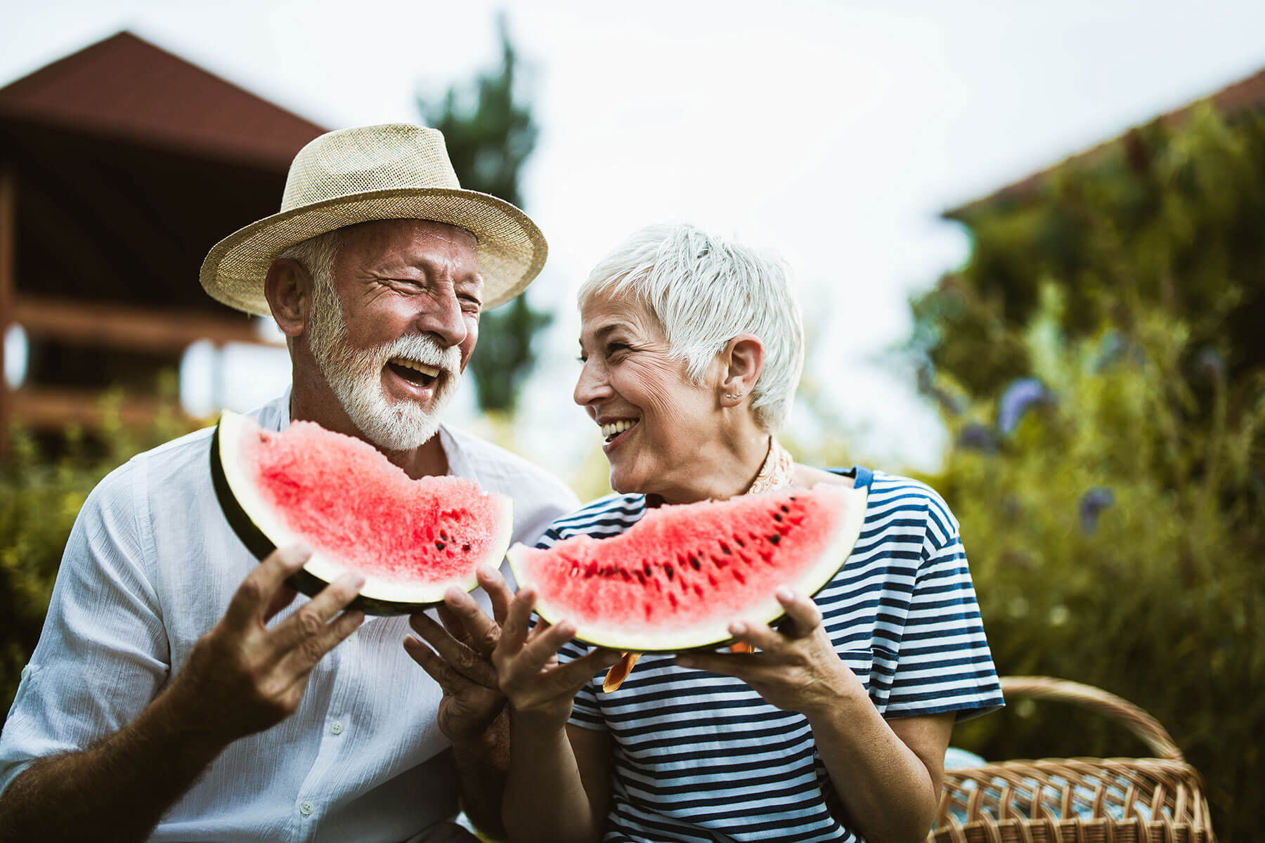 Senior couple eating watermelon